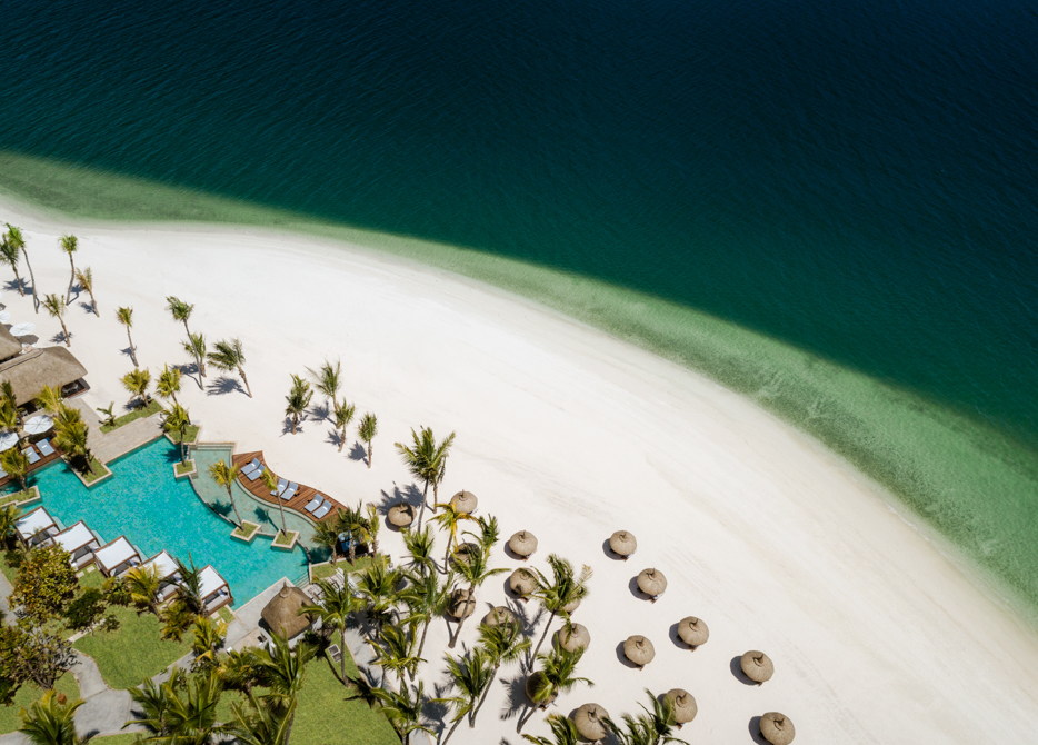 A private peninsula — the activity/scene in action. Seclusion you reach only as a guest, between lagoon and ocean.