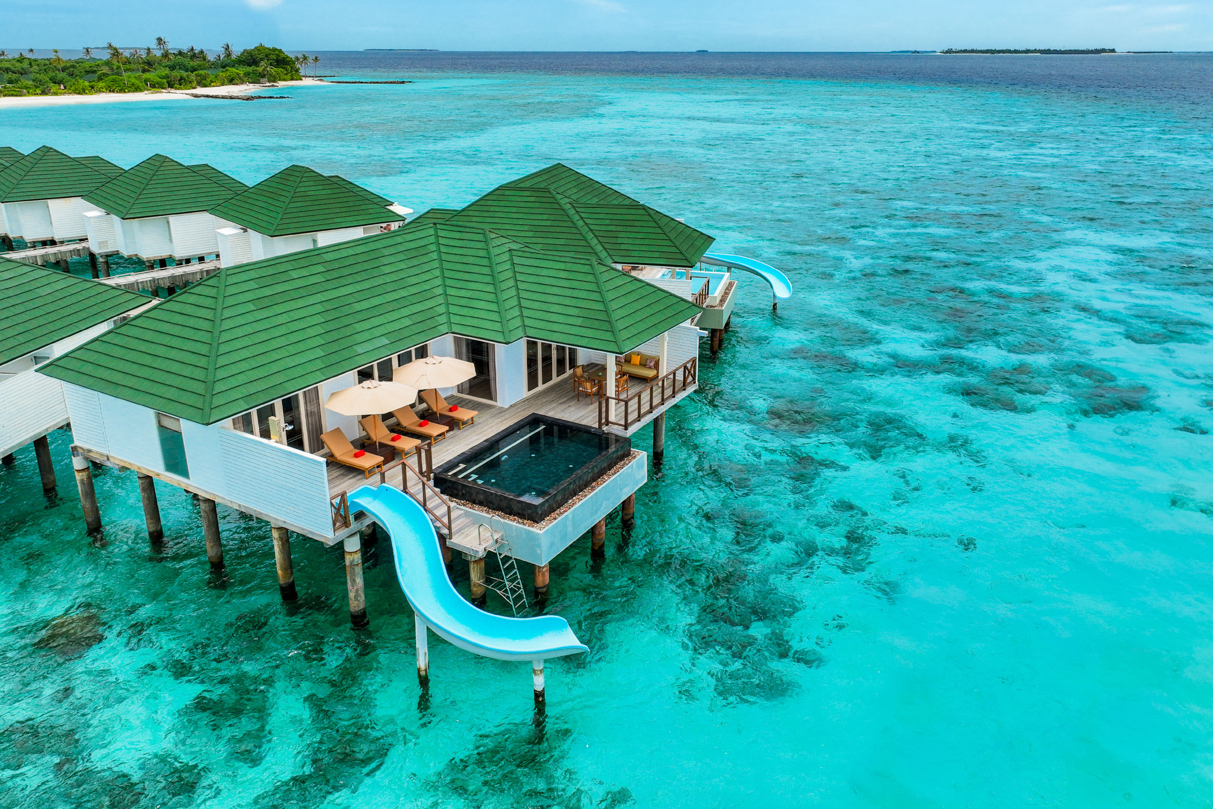 Slide villas into the lagoon — the activity/scene in action. Overwater villas with slides straight into the water.