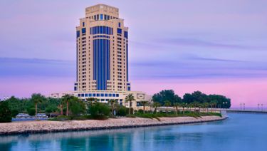 Hero/establishing shot of The Ritz-Carlton, Doha, Doha, Qatar. A luxury island hotel on its own exclusive island in the West Bay Lagoon, with a 235-slip marina and views of the Arabian Gulf, The Pearl and Lusail.