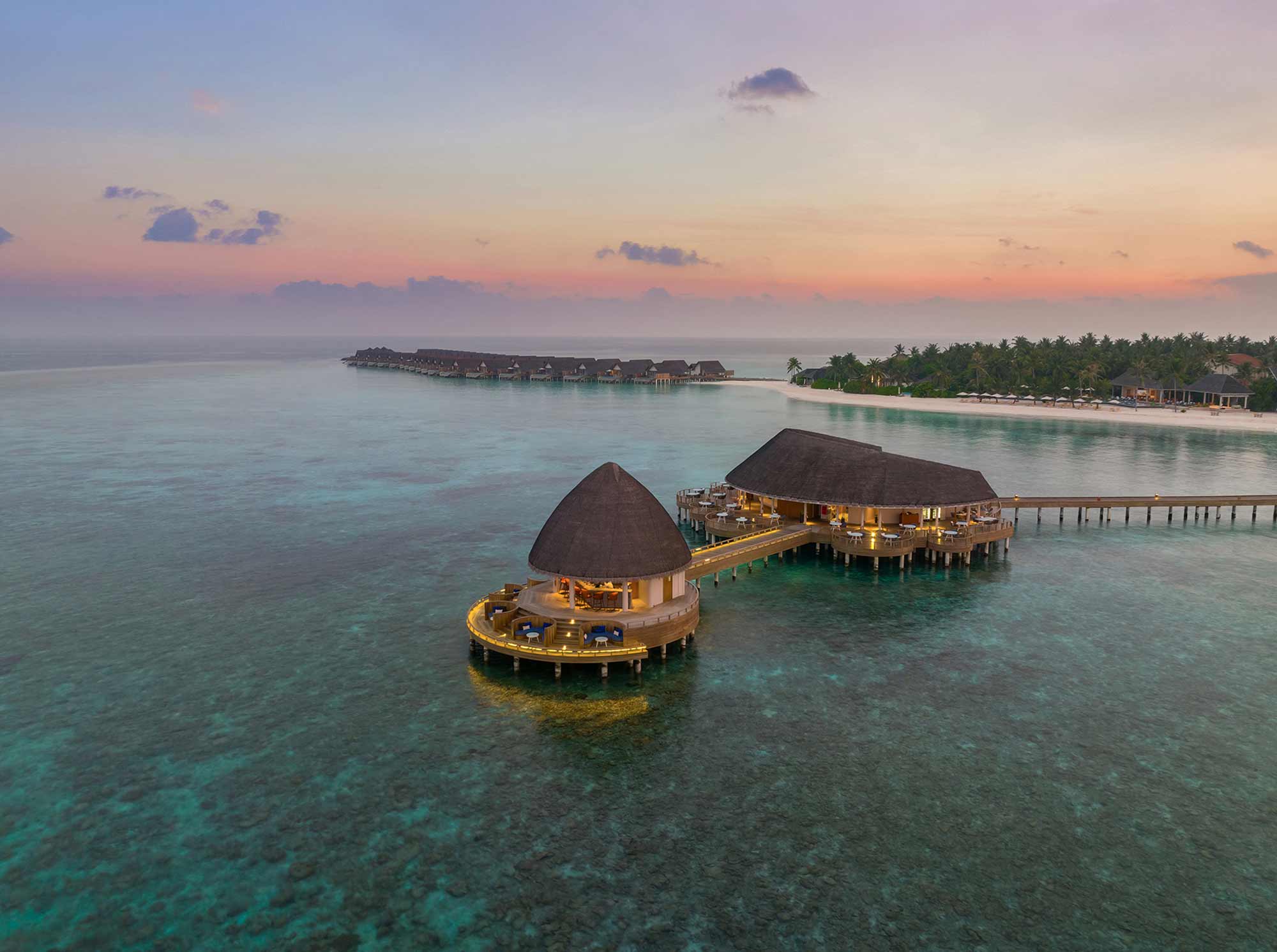 Signature hero of Emerald Faarufushi Resort & Spa (Raa Atoll, Maldives): the single most iconic wide view — Private island, Deluxe all-inclusive, Leading Hotels of the World. Golden-hour, landscape, room to overlay text.