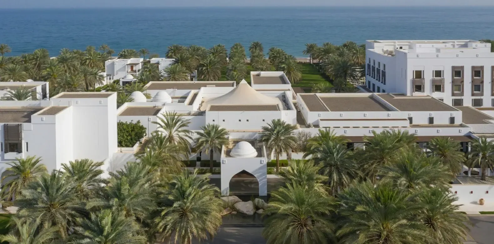 Hero/establishing shot of The Chedi Muscat, Muscat, Oman. Oman’s design icon — a Jean-Michel Gathy-designed, Omani-Asian minimalist beach resort in a 21-acre garden oasis, with the region’s longest pool at 103 metres.