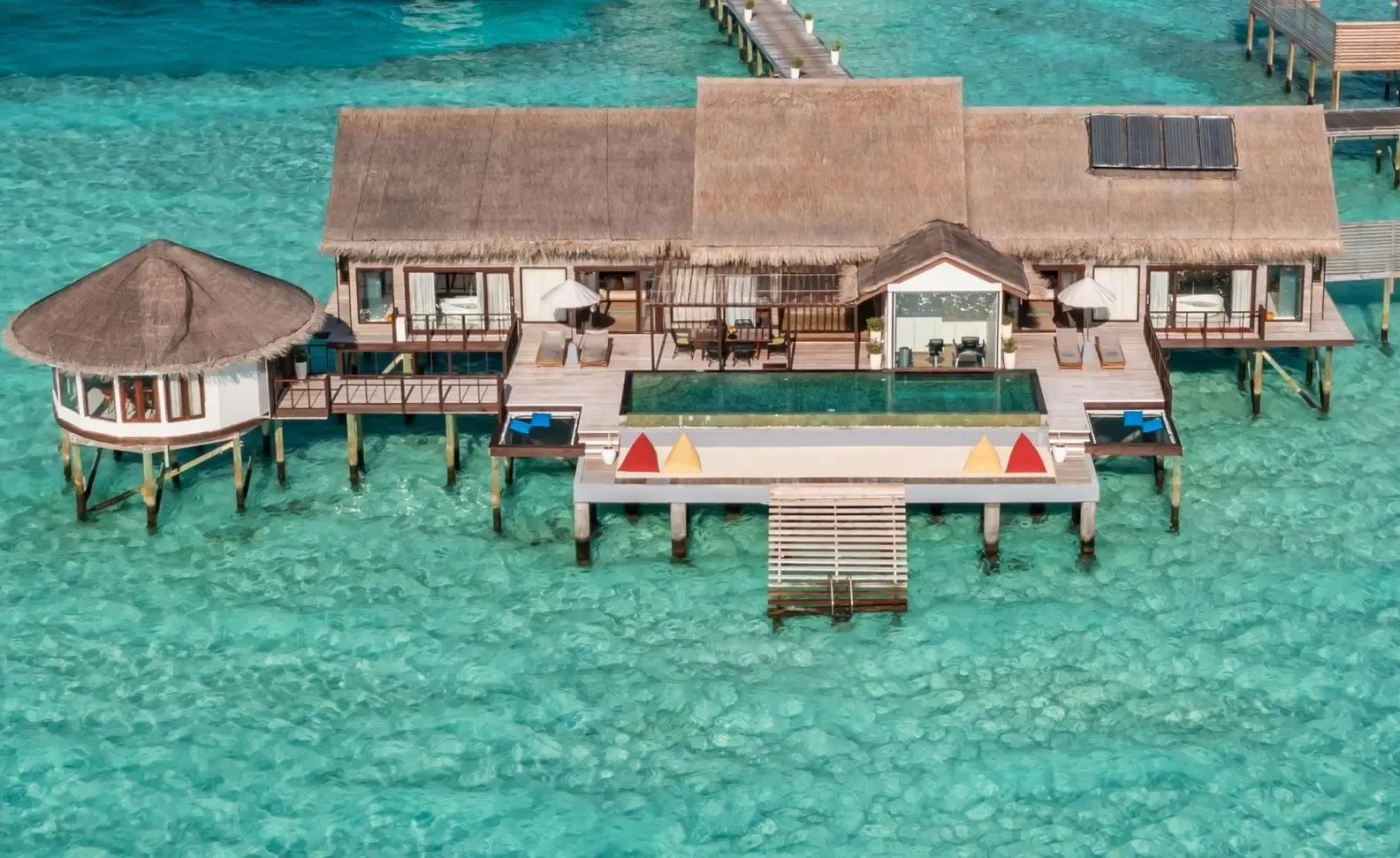 Signature hero of OZEN LIFE MAADHOO (South Malé Atoll, Maldives): the single most iconic wide view — Luxury all-inclusive, Underwater restaurant, Included transfer. Golden-hour, landscape, room to overlay text.