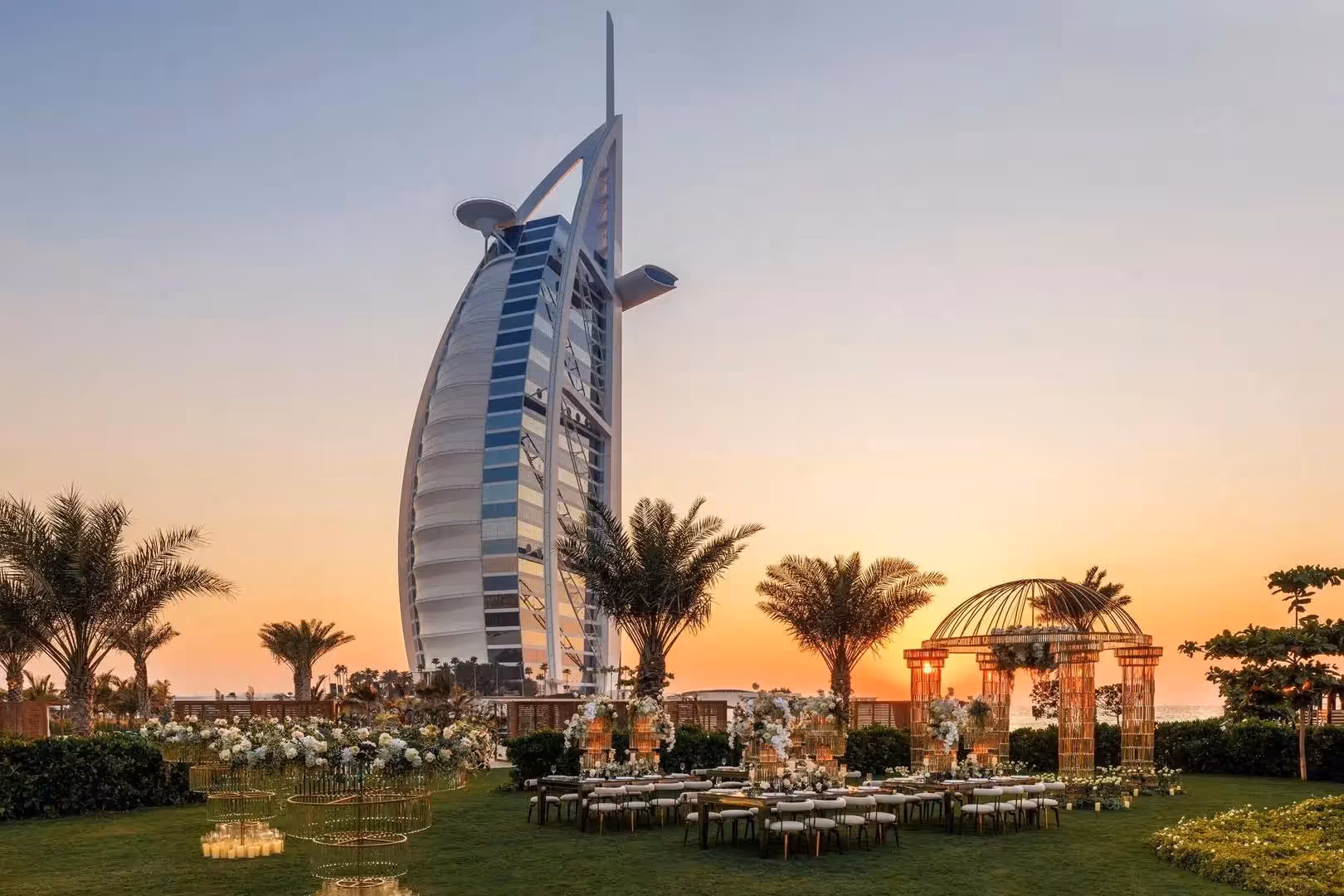 Hero/establishing shot of Burj Al Arab Jumeirah, Dubai. The single most recognisable building in Dubai — an all-suite sail-shaped landmark on its own island, reached by causeway.