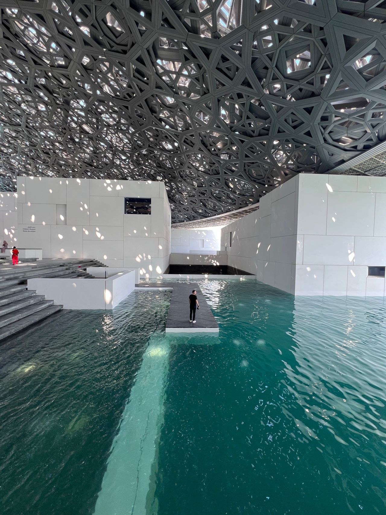 Jean Nouvel's lattice dome floats over the water, raining filtered light onto galleries that span human history