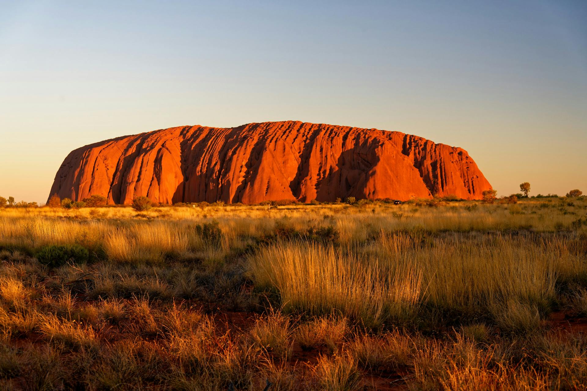 The vast red monolith at the spiritual heart of the continent, glowing at sunrise and sunset