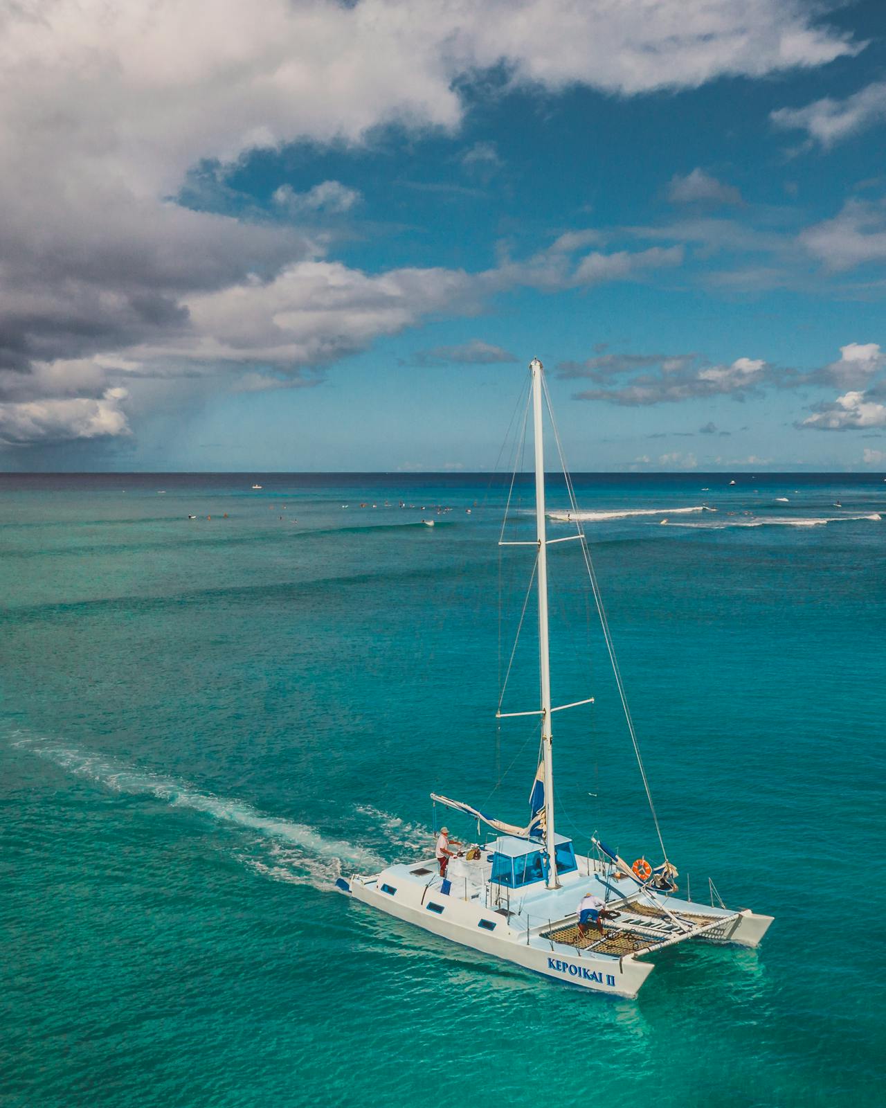 Sail the Platinum Coast with lunch and rum punch aboard, anchoring over turtle grounds and shipwrecks to snorkel