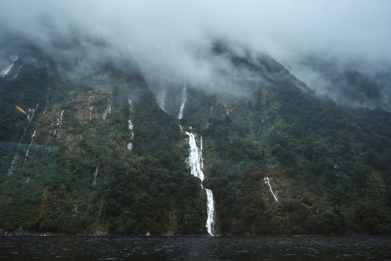 The sheer cliffs and waterfalls of Milford Sound, cruised by boat beneath Mitre Peak