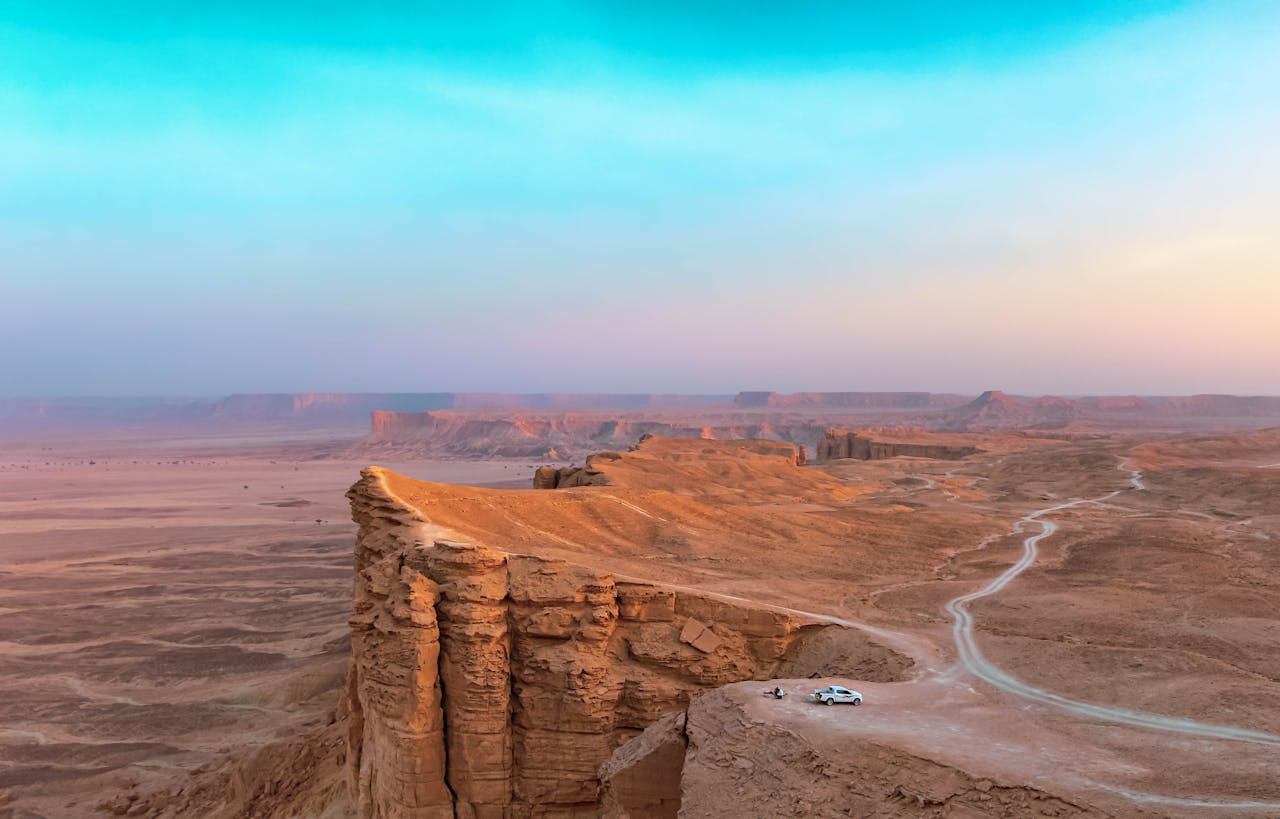 Near Riyadh, a sheer cliff drops away to a desert plain that runs unbroken to the horizon
